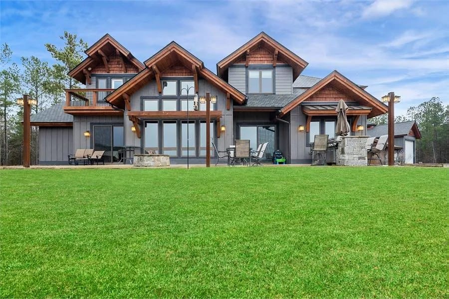 Rear view of the house showcasing the outdoor living and expansive windows.