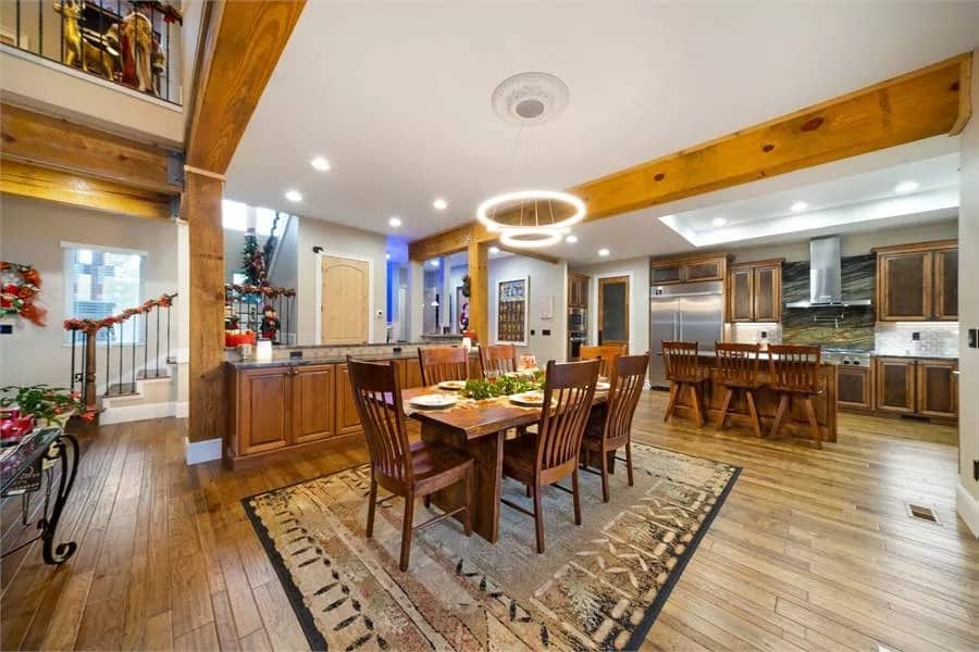 Dining room with a wooden dining set over a tribal area rug.