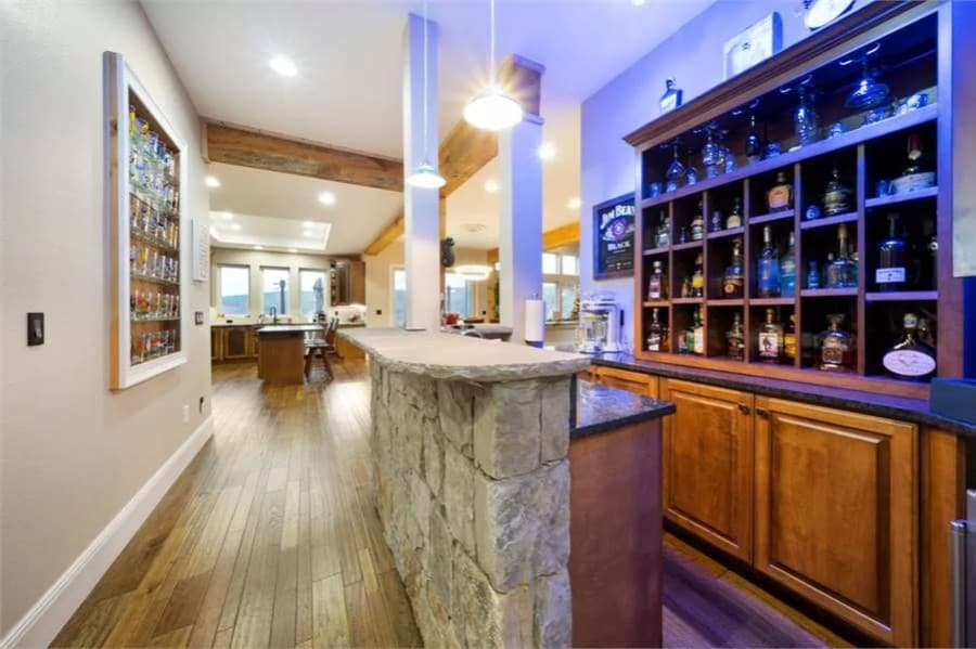 Home bar with built-in cubbies and a raised eating bar.