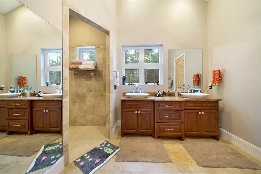 Primary bathroom with a dual sink vanity and a walk-in shower.