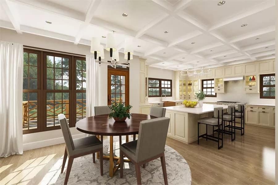 Dining area with a round dining set under a coffered ceiling.