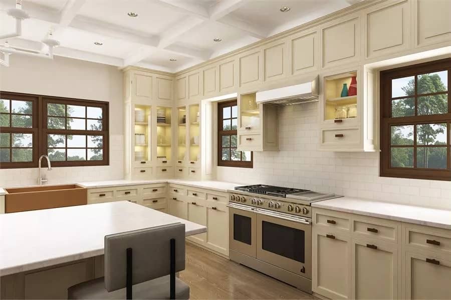 Kitchen with cream cabinetry, a center island, and a farmhouse sink under the wooden-framed windows.