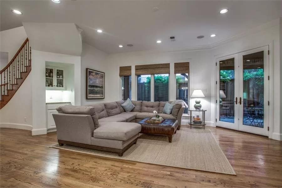 Family room with a sectional sofa and a leather ottoman over the jute area rug.