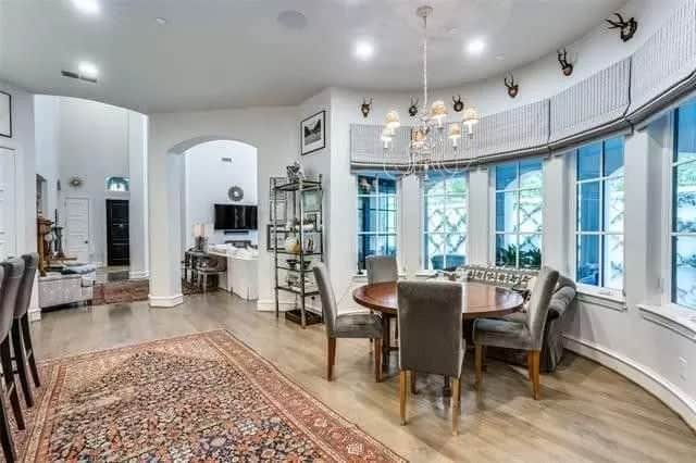 Breakfast nook with a round dining set against the bow window.