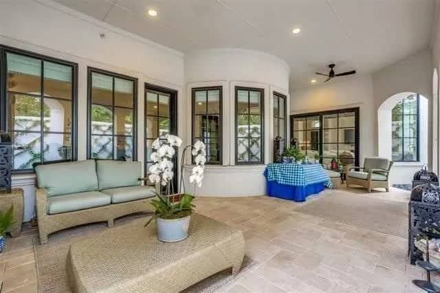 Covered veranda with multiple sitting areas over the limestone flooring.