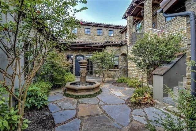 Courtyard with a fountain over the flagstone flooring.