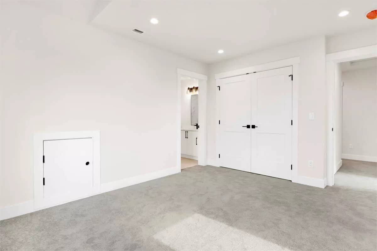 Secondary bedroom with carpet flooring and a built-in wardrobe.