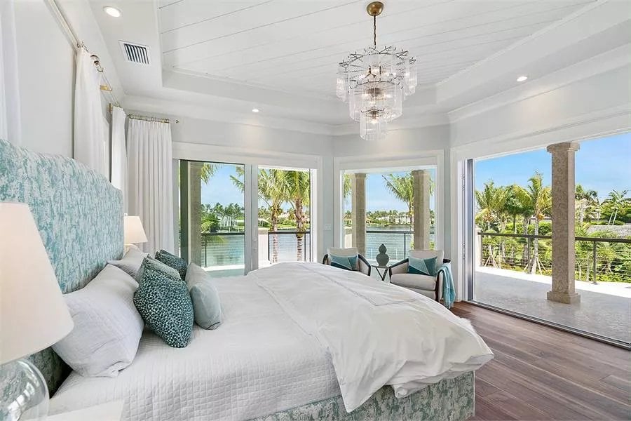 Sliding glass doors and a picture window brighten the guest suite.