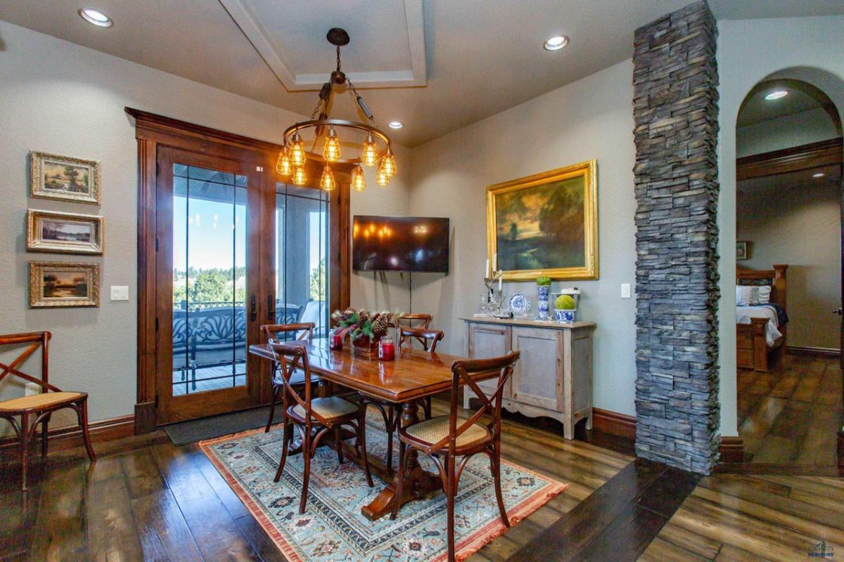 Breakfast nook with a chandelier and wood flooring.