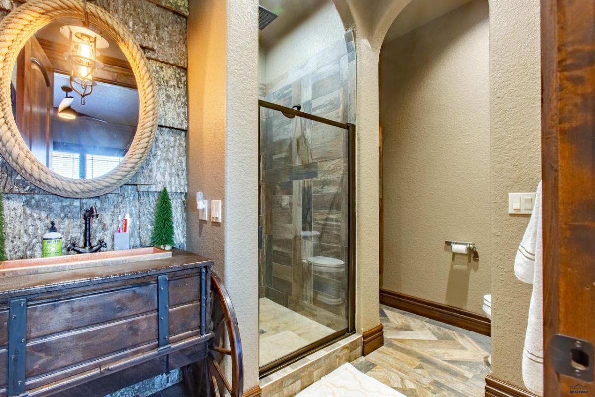 Bathroom with a sink and a walk-in shower.