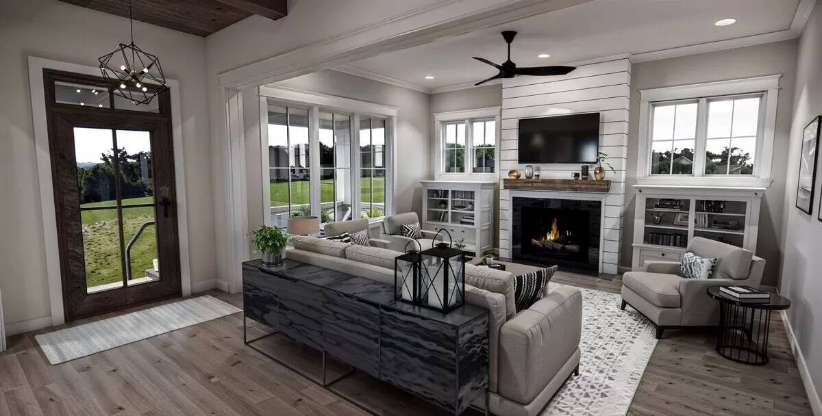 Great room with gray seats, a wall-mounted TV, and a fireplace flanked by glass-front cabinets.