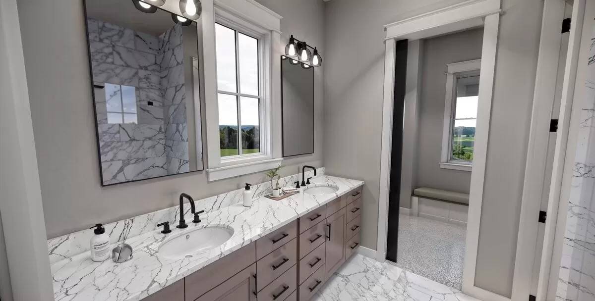 Primary vanity with two sinks and a marble counter that mirrors the tiled flooring.
