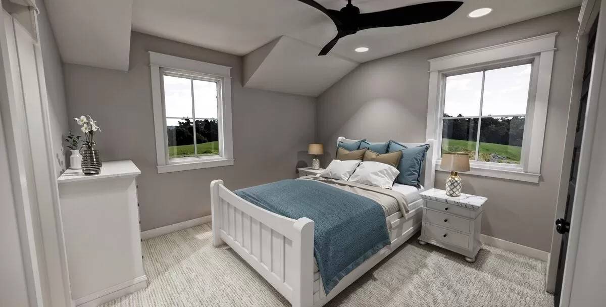 Secondary bedroom with white furnishings under a vaulted ceiling.