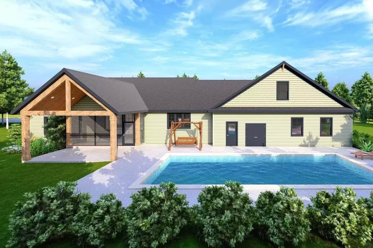 Rear view of the house with a covered patio and a swimming pool.