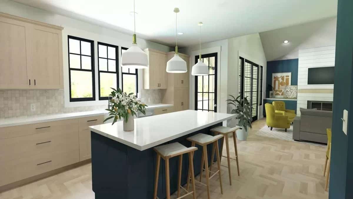 Kitchen with light wood cabinets and a breakfast island with seating for three.