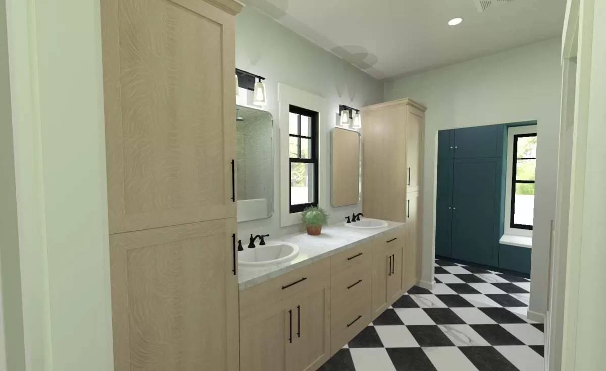 Primary bathroom with a dual sink vanity flanked by linen closets.