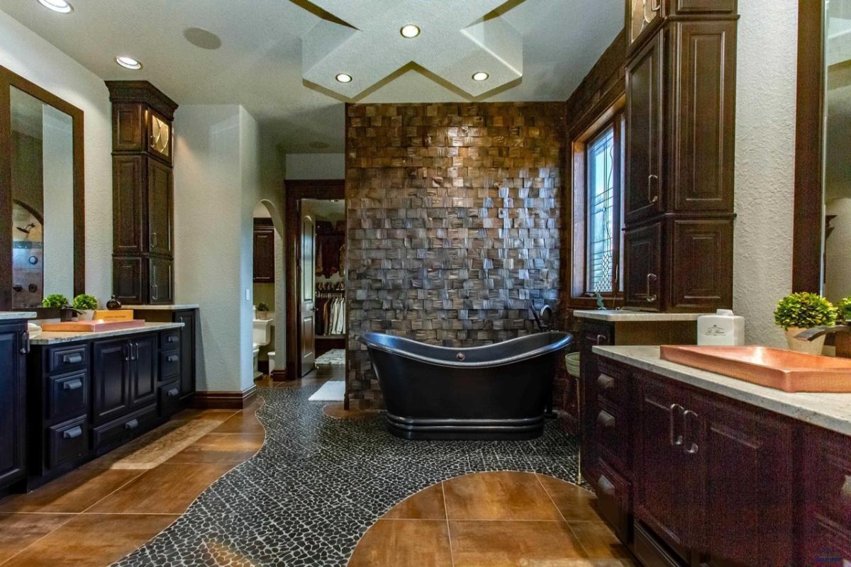 Bathroom with a sink and a soaking tub.