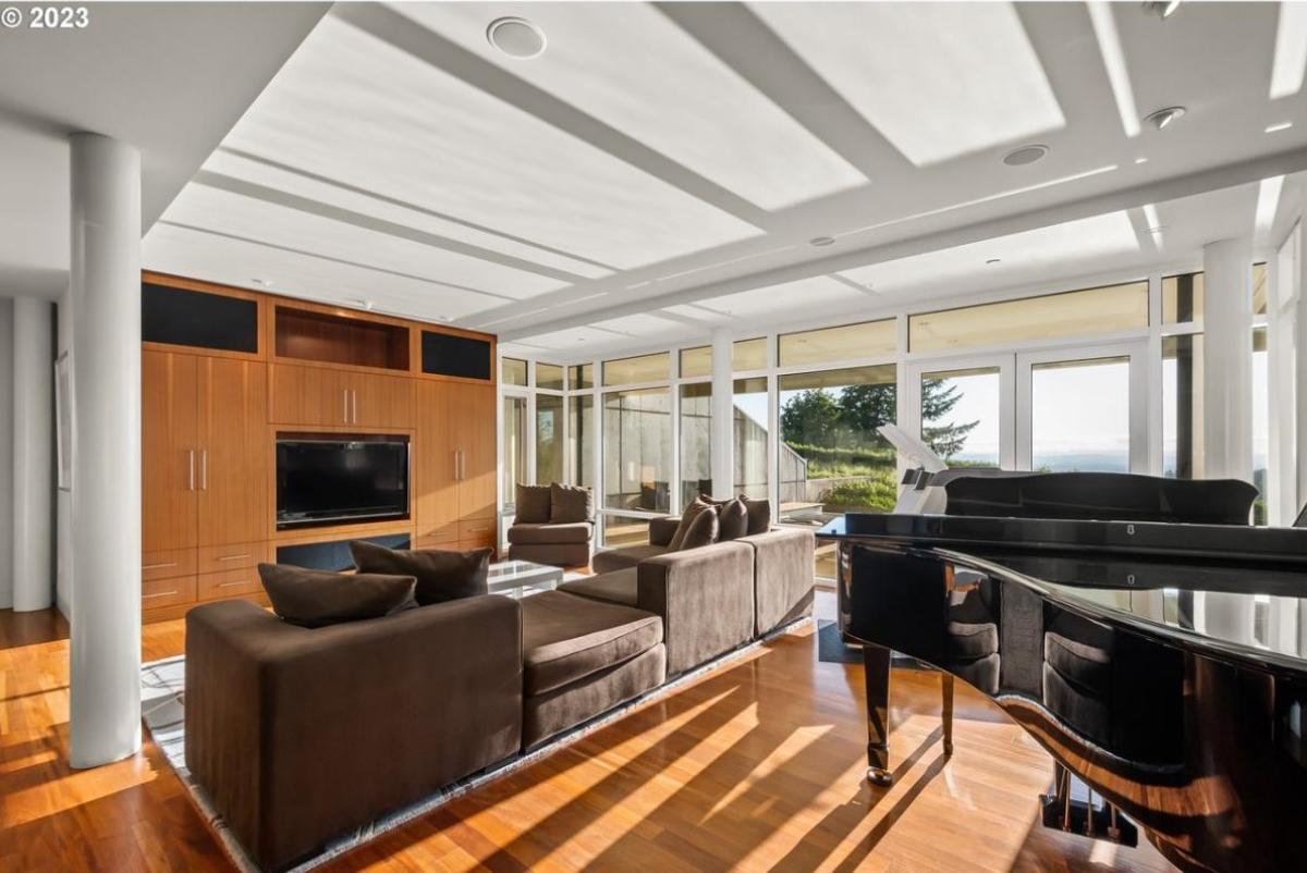 Recreation room with a TV, couch, and a piano.