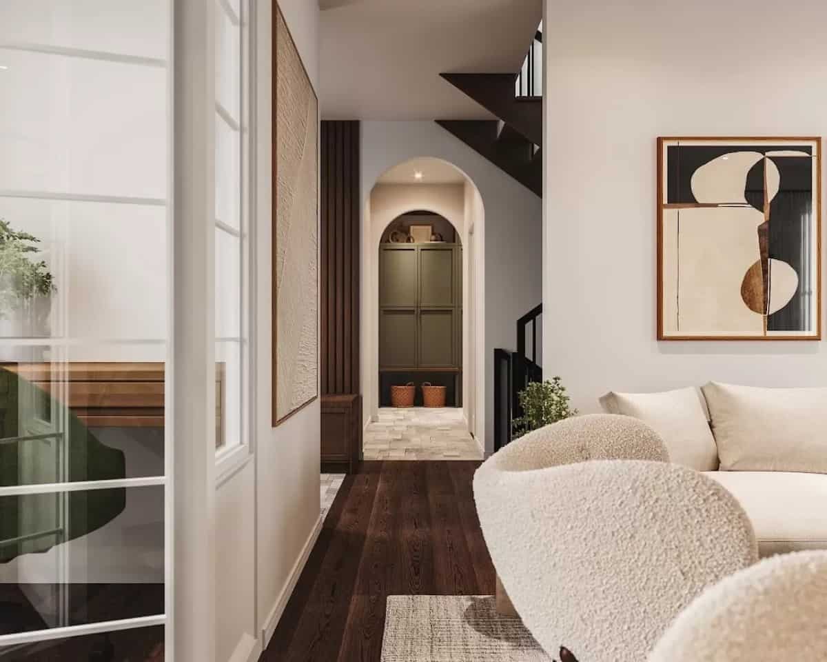 Foyer with an archway and hardwood flooring.