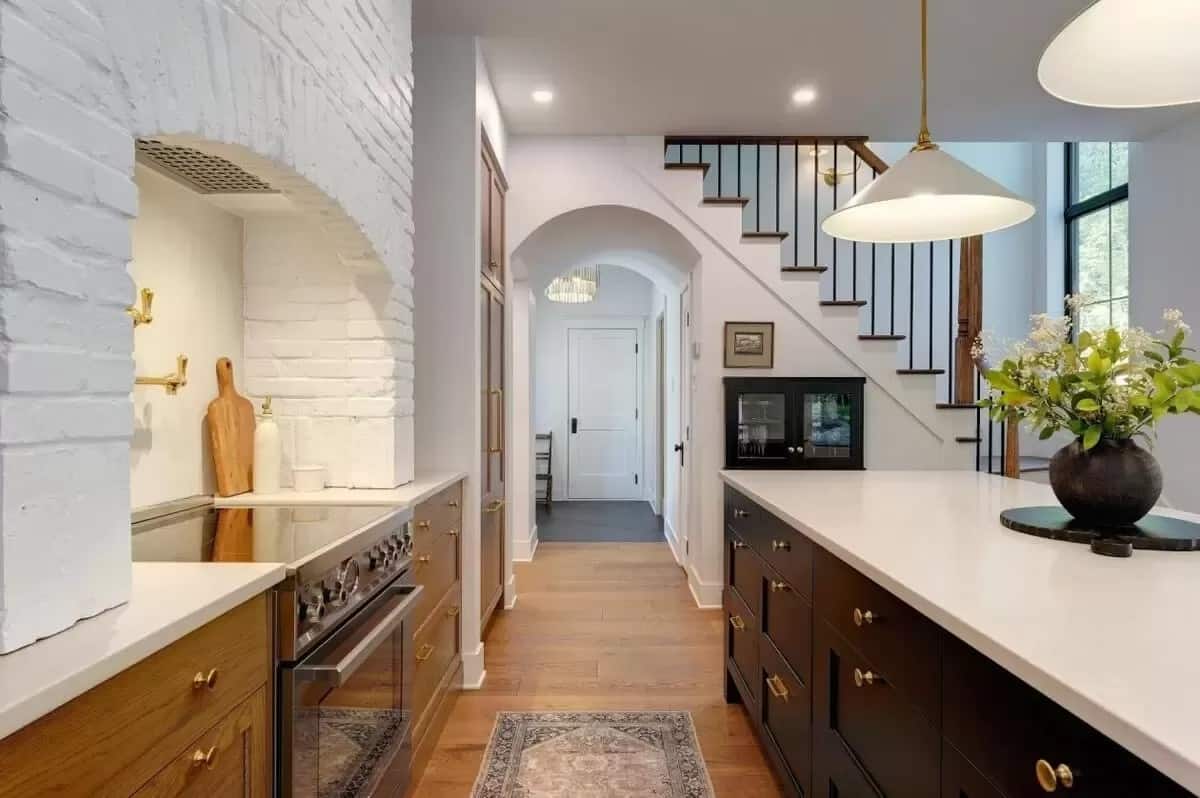 The kitchen includes a cooking alcove and a large breakfast island.