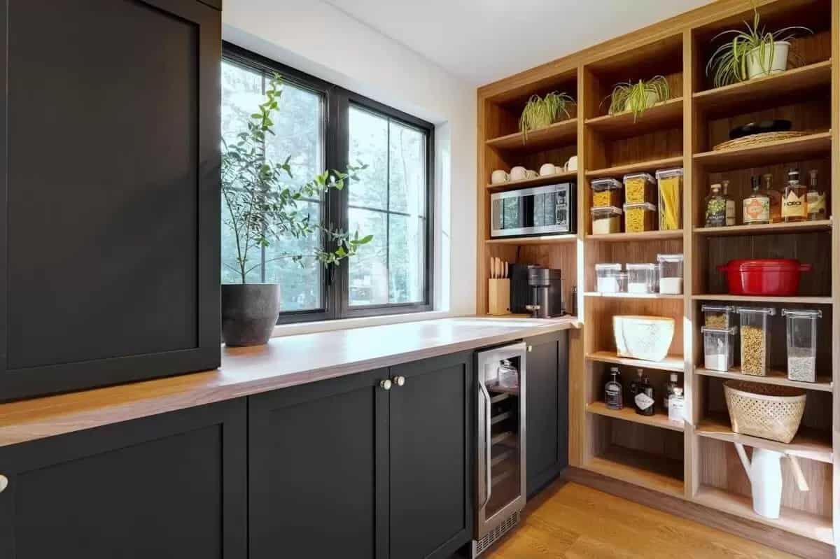 Walk-in pantry with open shelves, black cabinets, and a wine fridge.