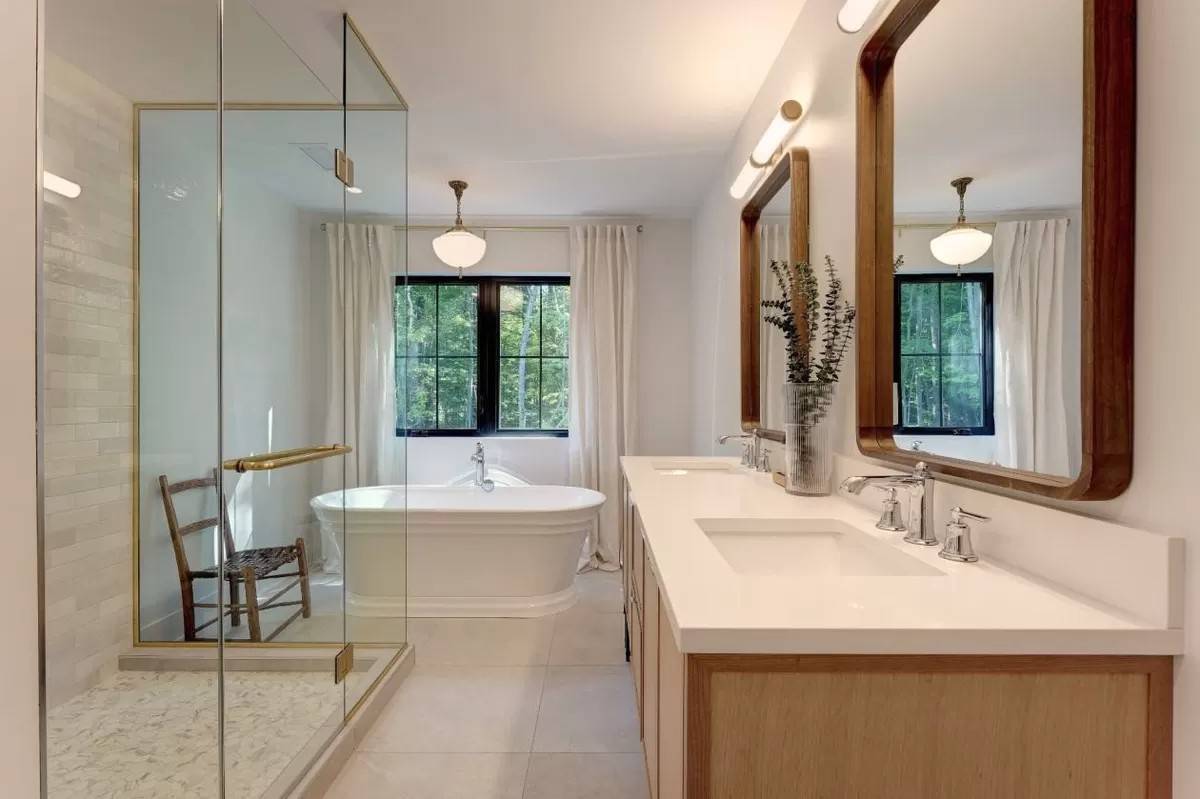 Primary bathroom with a dual sink vanity, a tiled shower, and a soaking tub.