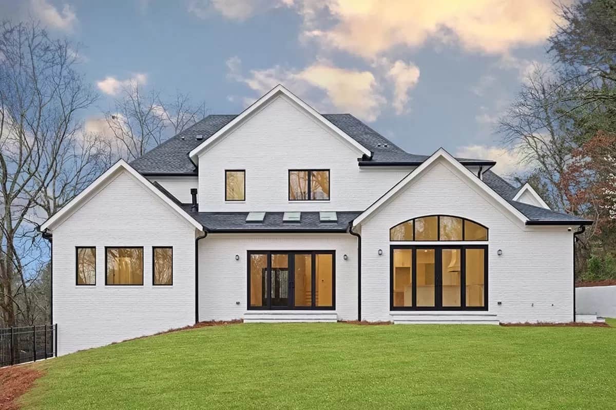 Rear view with sliding glass doors and arched transoms.