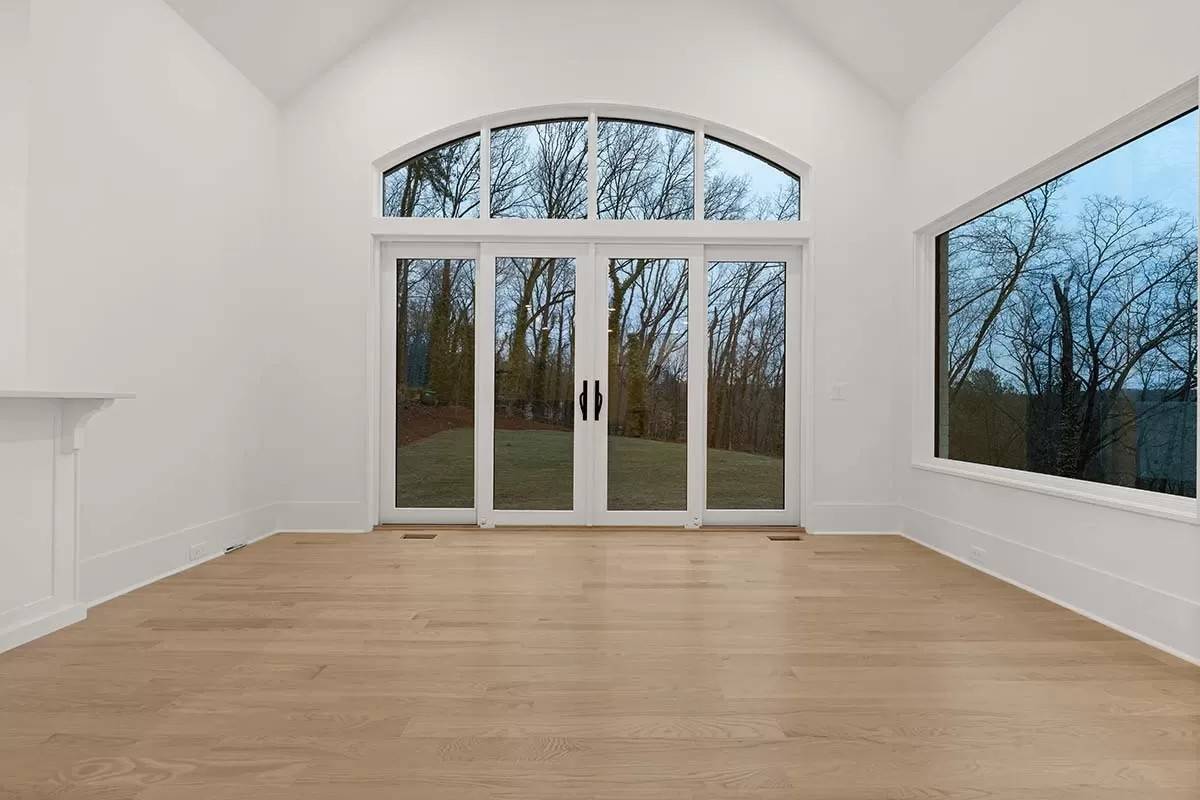 Dining room with a cathedral ceiling and sliding glass doors that open to the backyard.