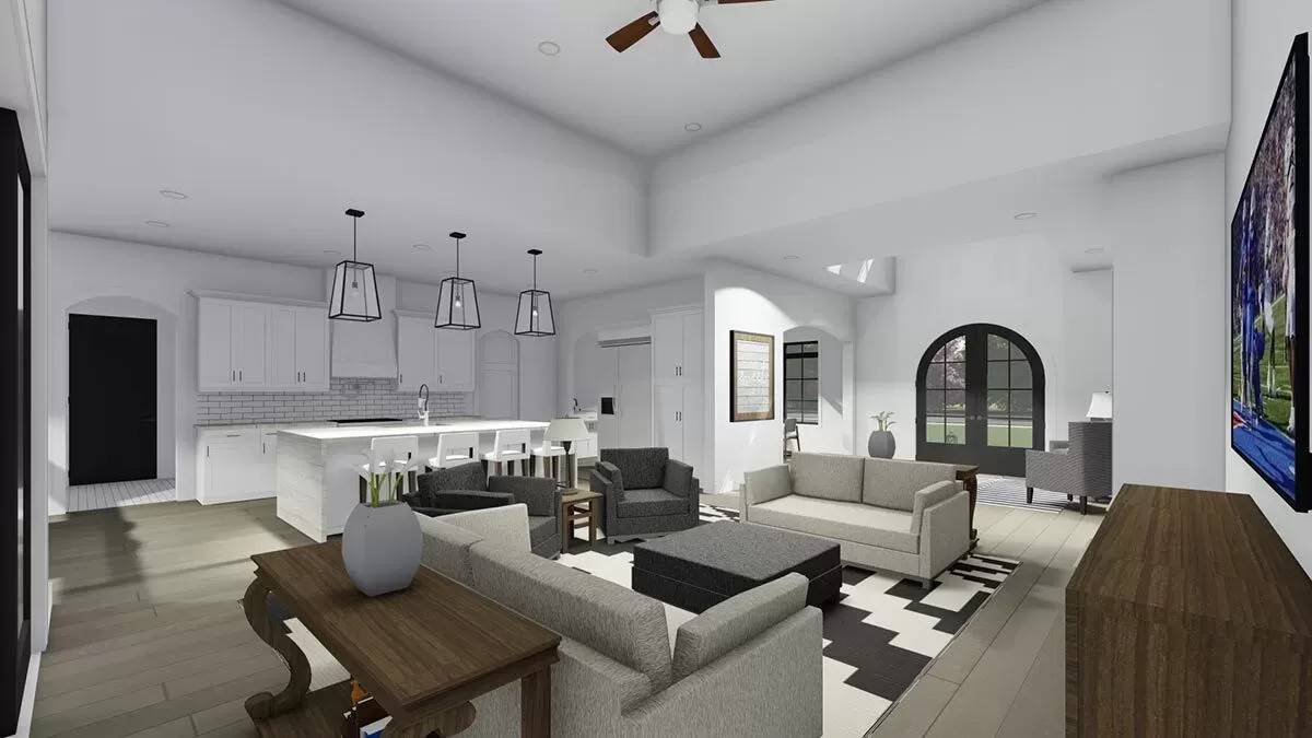 Great room and kitchen with hardwood flooring and white walls.