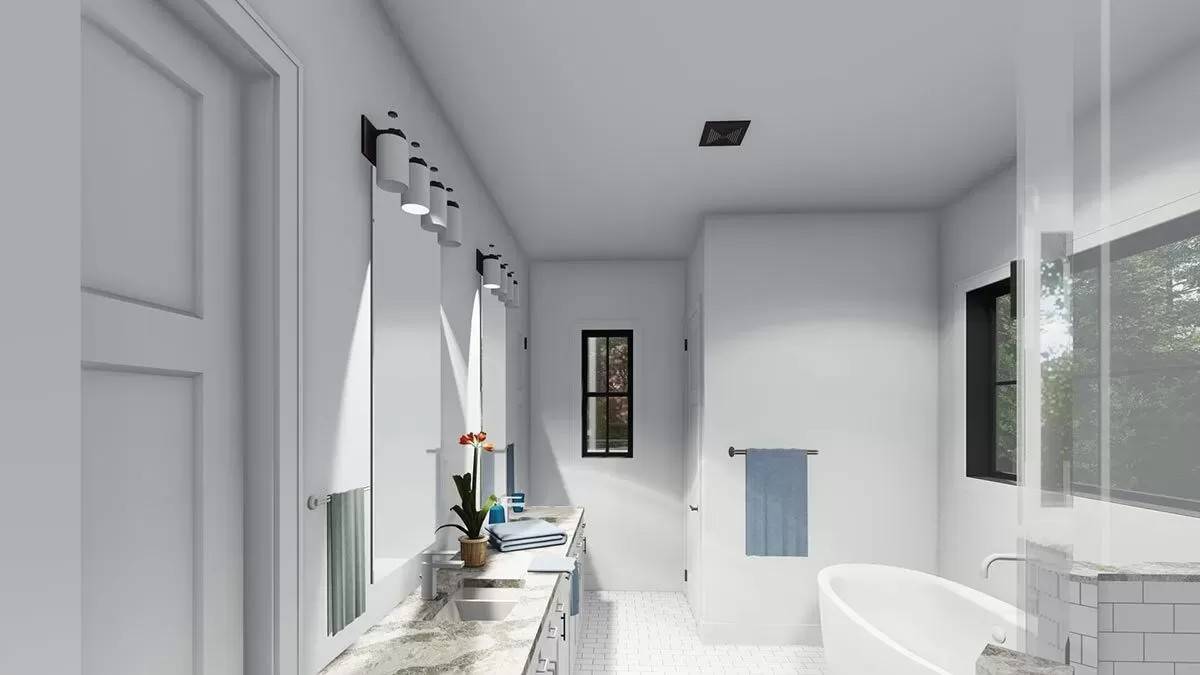 Primary bathroom with a large vanity and a soaking tub brightened by black-framed windows.