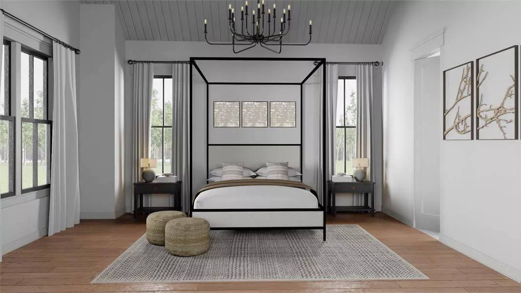 Primary bedroom with large windows and a canopy bed under a vaulted ceiling.