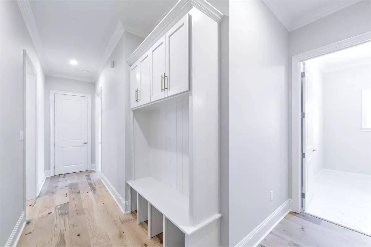 Mudroom with built-in cabinets, cubbies, and bench.