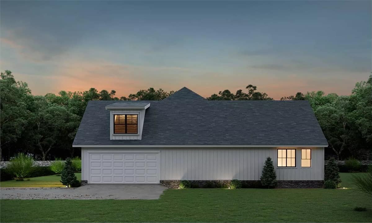 Right view of the house with a double garage topped by a shed dormer.