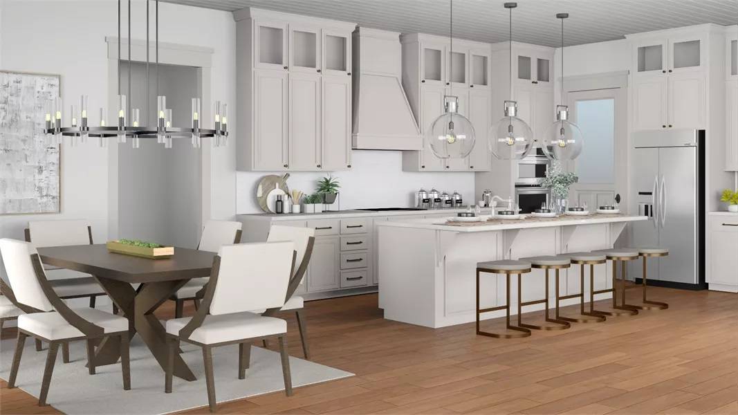 Kitchen and dining area with white cabinetry, a matching island, and a dark wood dining set.
