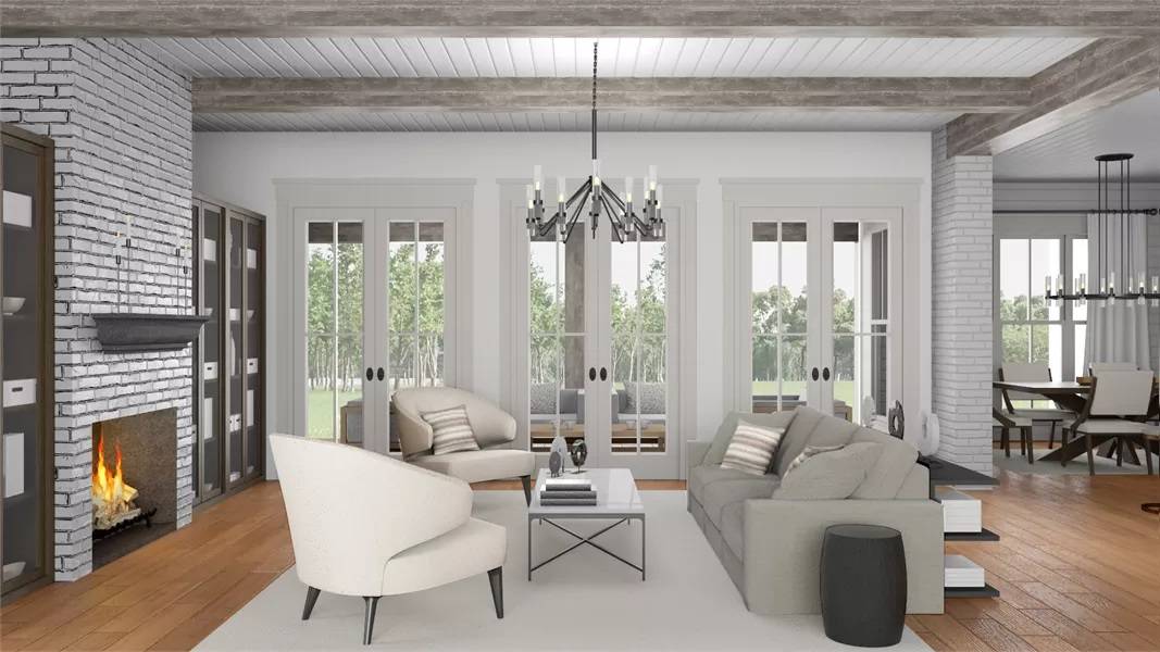 Great room with modern seats and a brick fireplace under a beamed ceiling.
