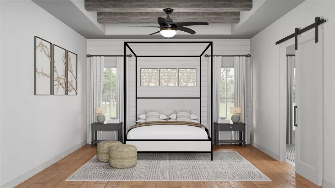 Primary bedroom with a canopy bed and a tray ceiling lined with rustic beams.