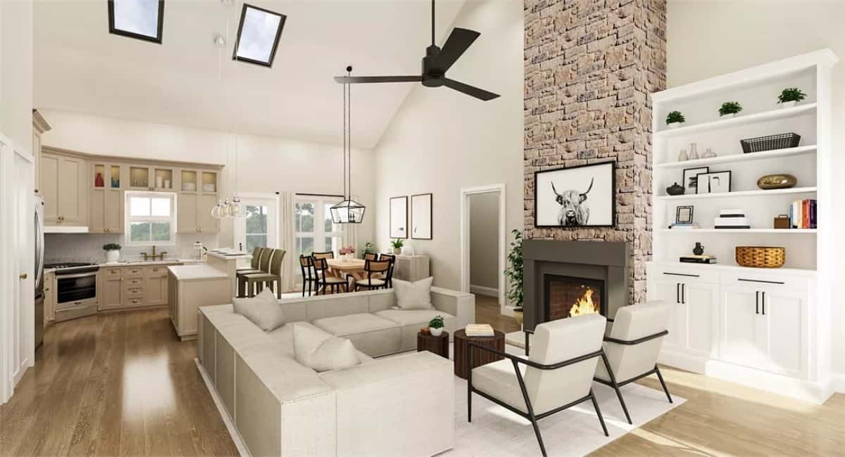 Living room with modern seats, a white cabinet, and a stone fireplace under a cathedral ceiling.
