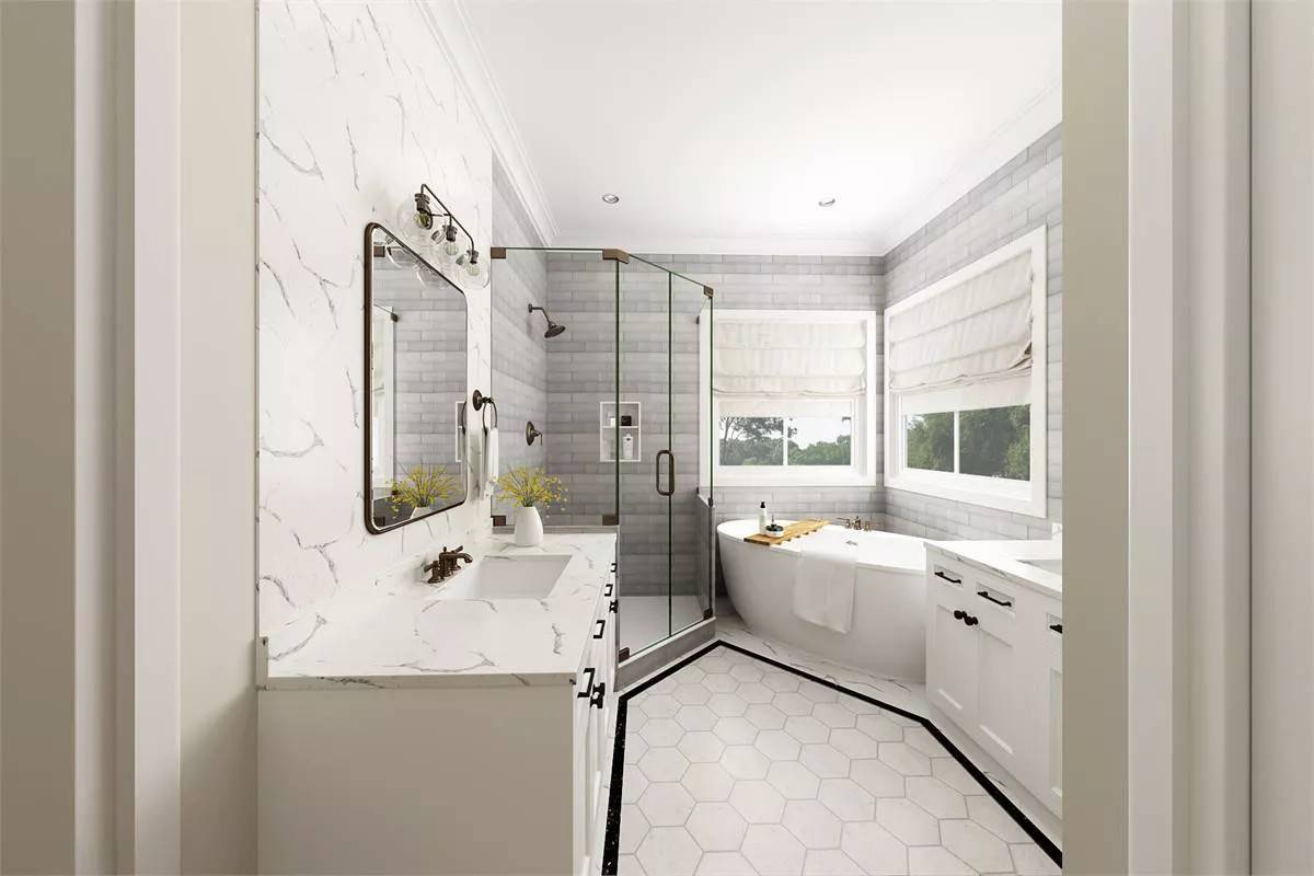 Primary bathroom with his and her vanities, a walk-in shower, and a soaking tub.