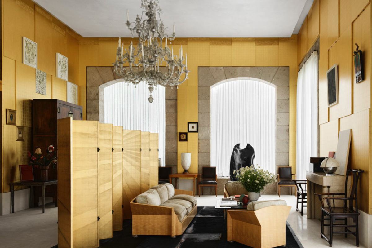 An informal living room with a chandelier and couches.