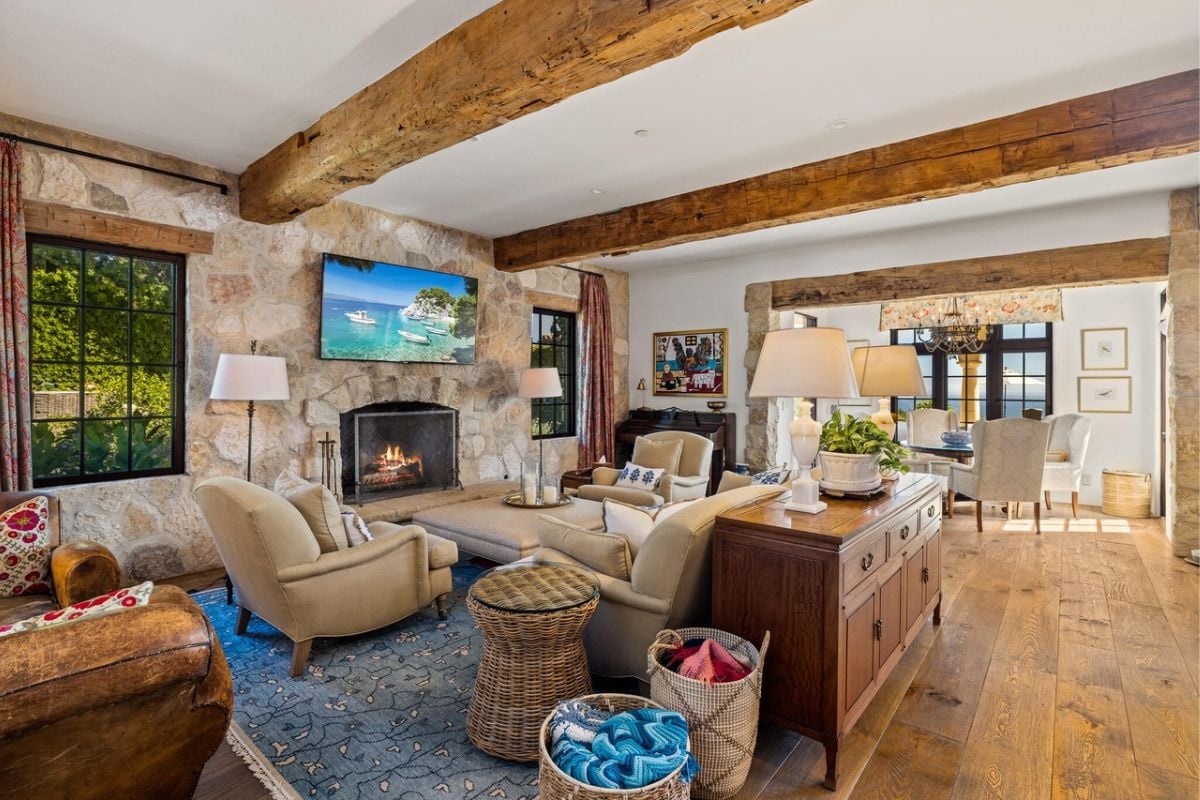 A living room with a fireplace and TV, featuring indoor furniture such as a couch and coffee table.