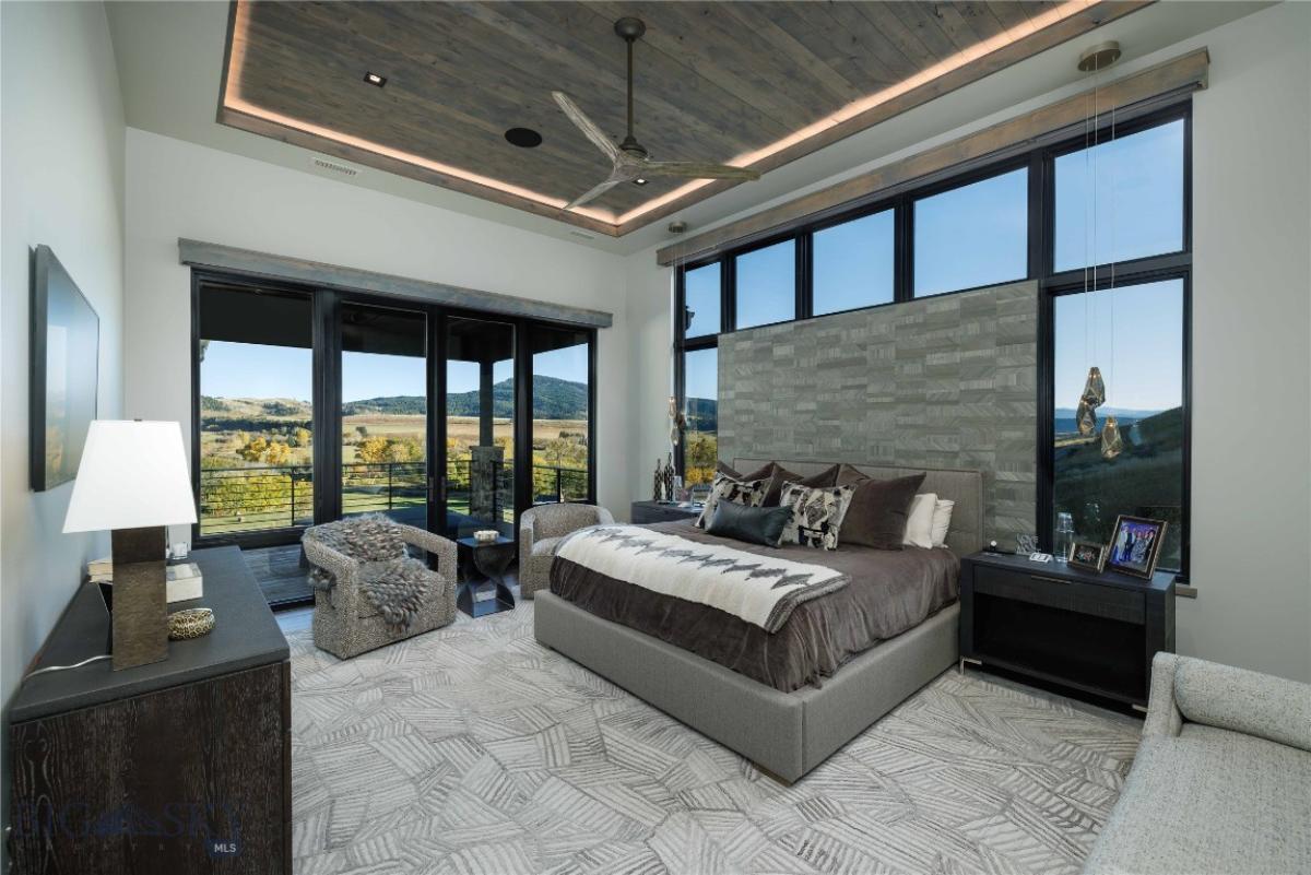 Bedroom with custom lights and expansive sliding glass doors.
