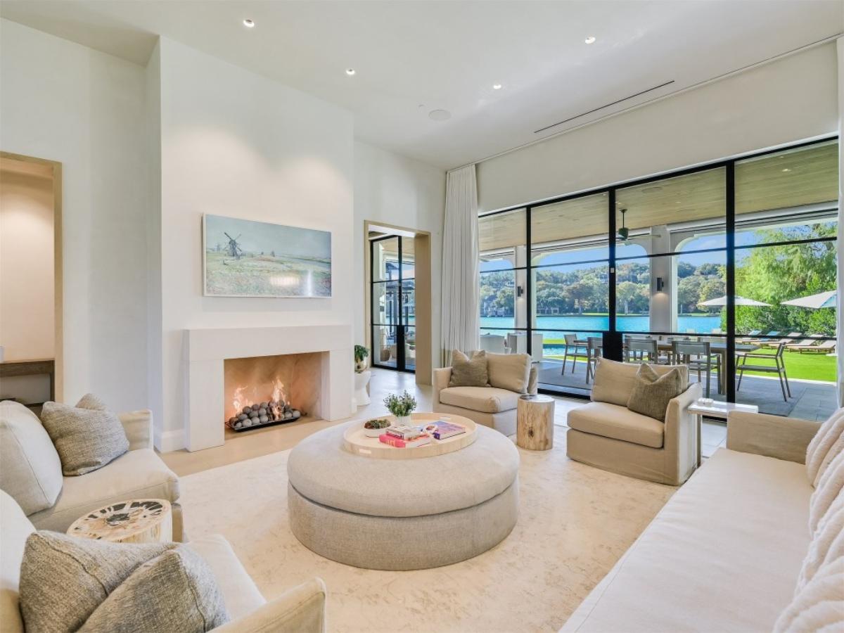 Living room with chairs and fireplace.