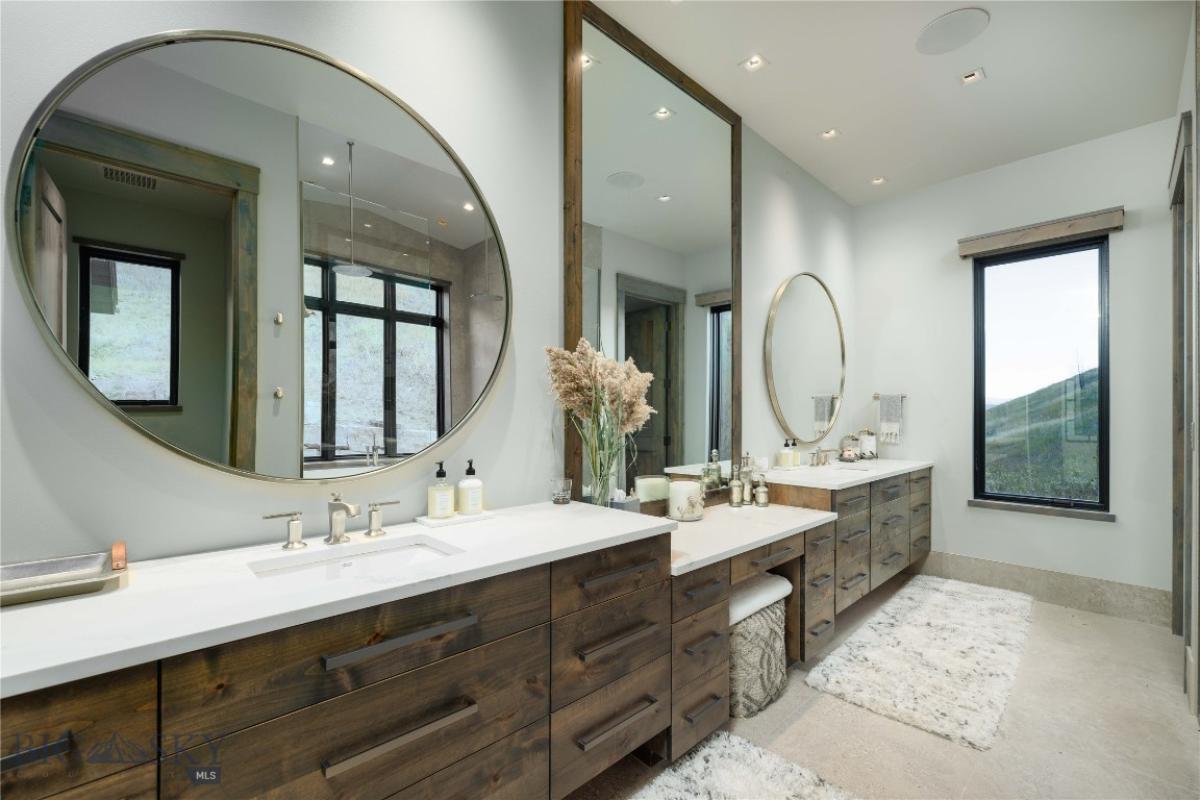 Bathroom with sinks, custom lights and large mirrors.