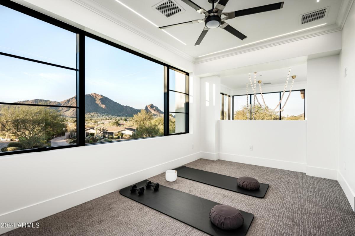 Yoga room carpet flooring and glass windows.