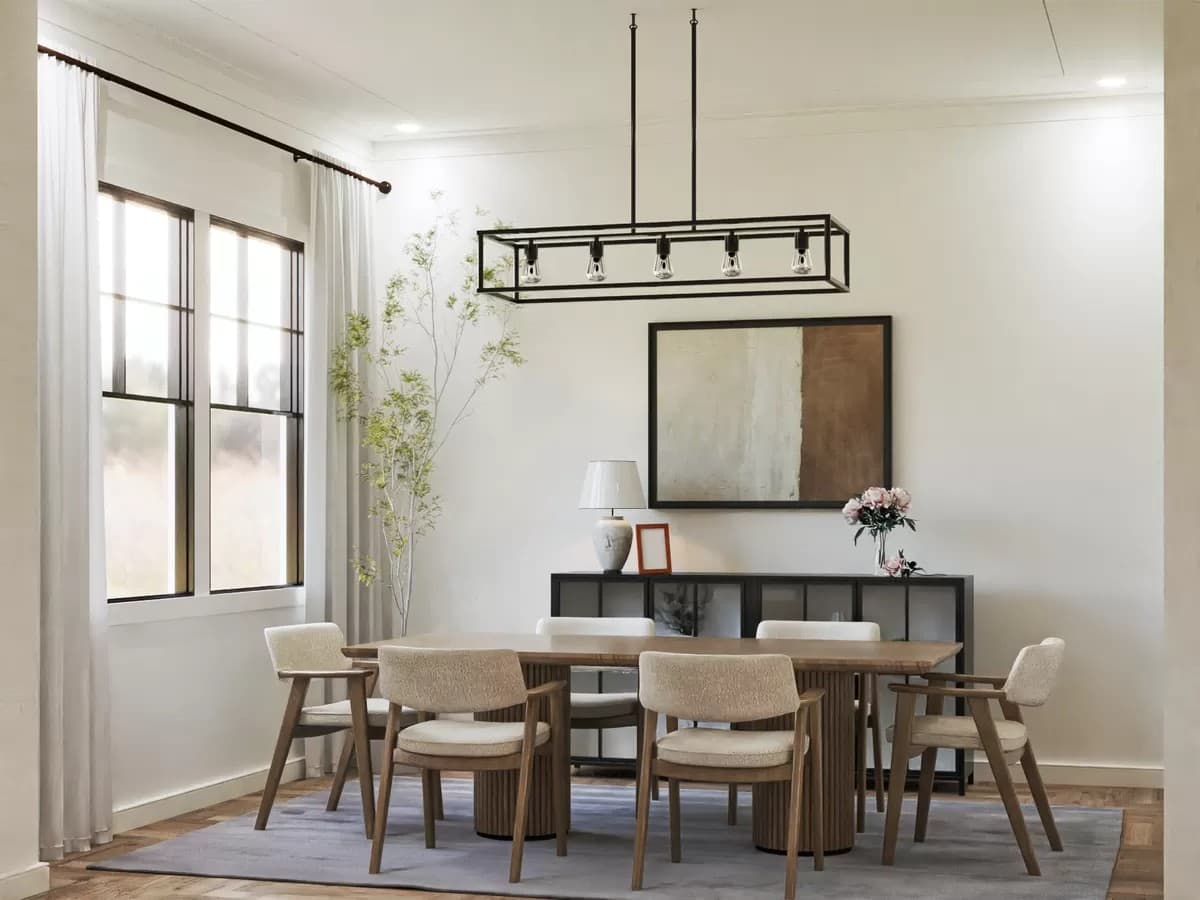 Dining room with cushioned chairs and a wooden table topped by a linear chandelier.