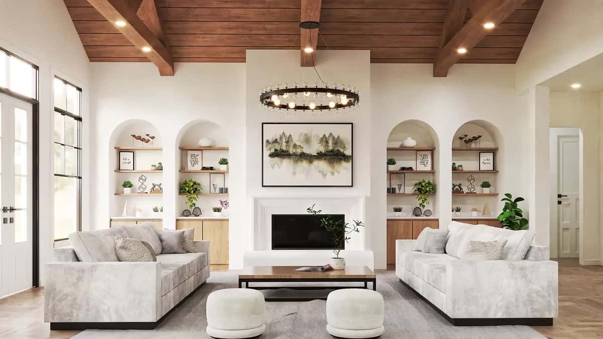 Family room with facing sofas, arched insets, and a fireplace under a vaulted ceiling.