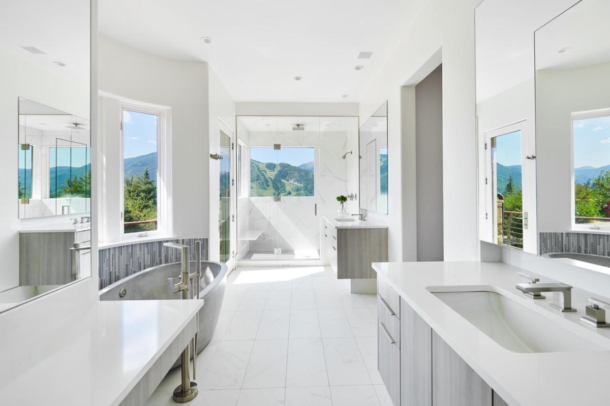 Bathroom with a soaking tub, sink, mirror and walk-in shower.