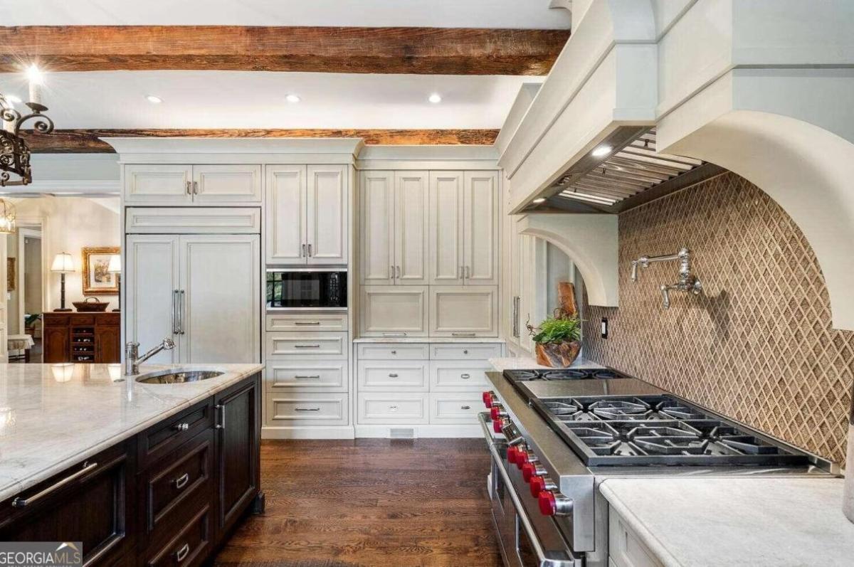 Kitchen with cooking area, custom lights and open beam ceiling.