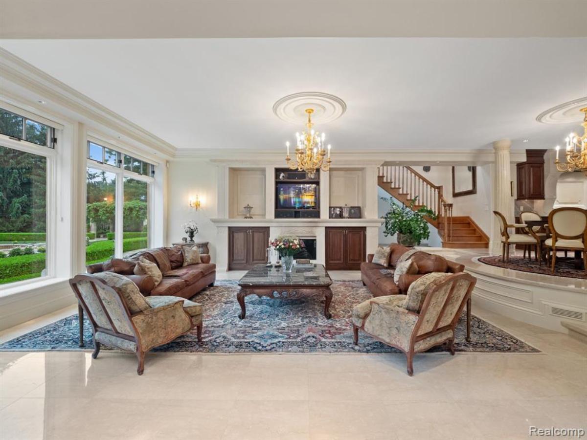 Living room with couches, TV and a fireplace.