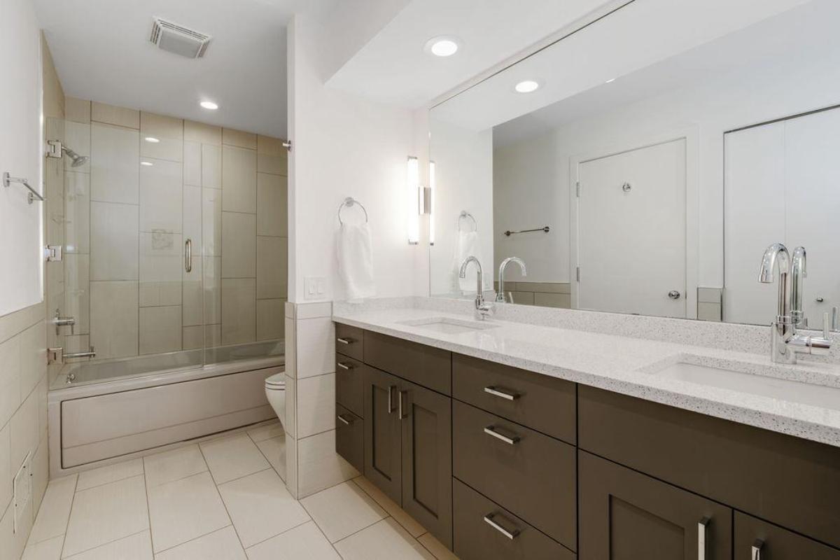 Bathroom with sinks, soaking tub and a shower.